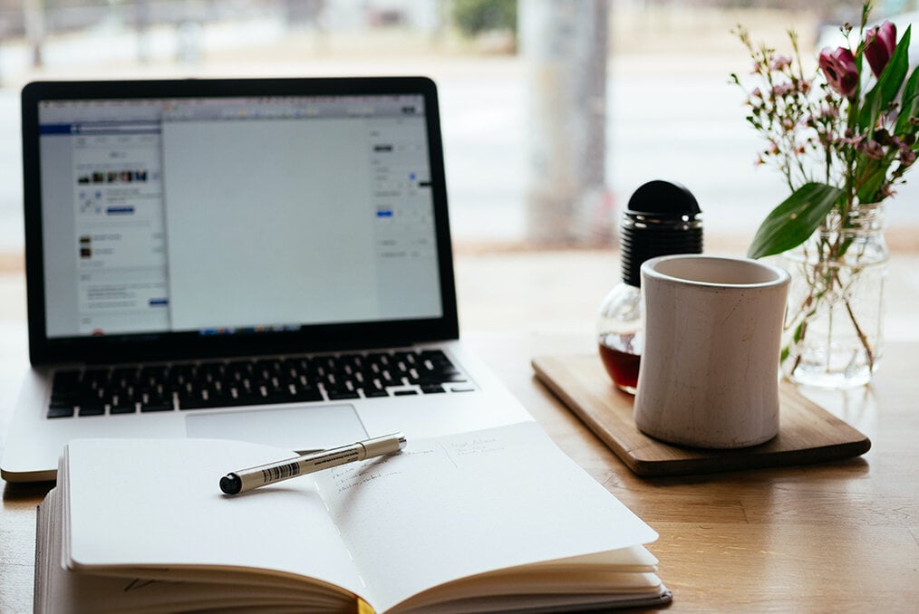 A computer and notebook opened up